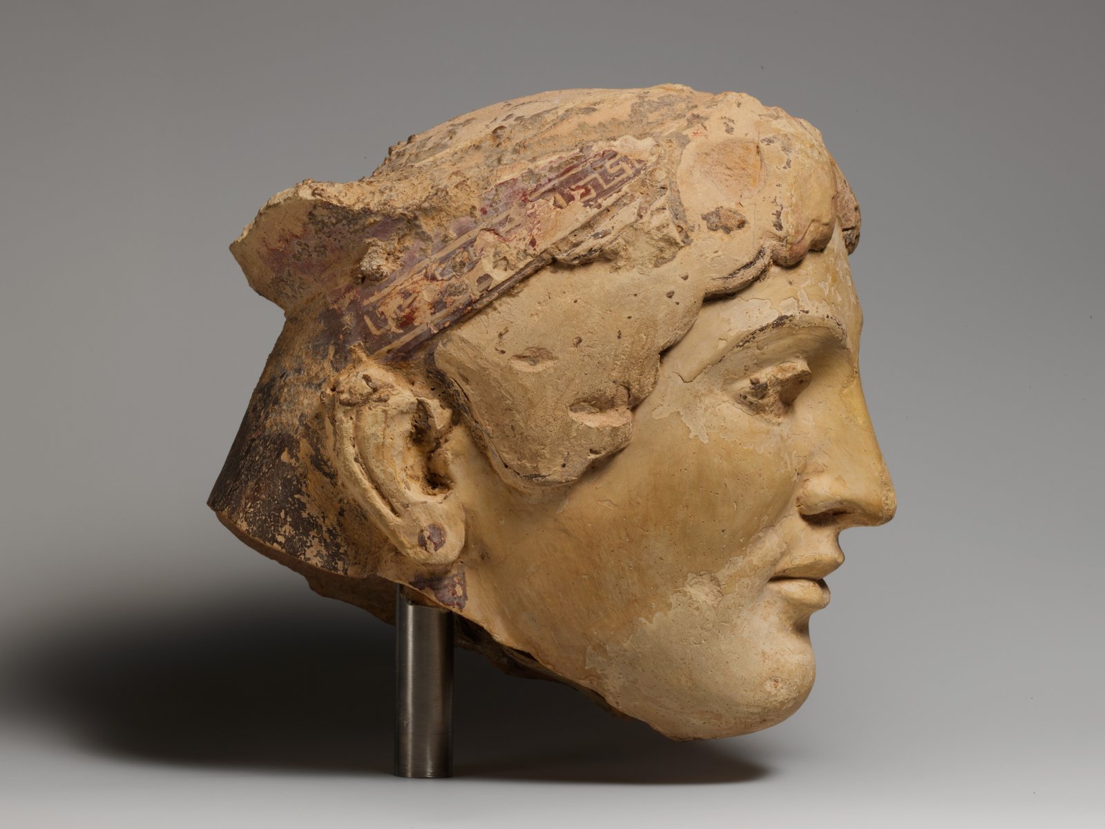 Terracotta head of a woman, probably a sphinx - Greek - Archaic